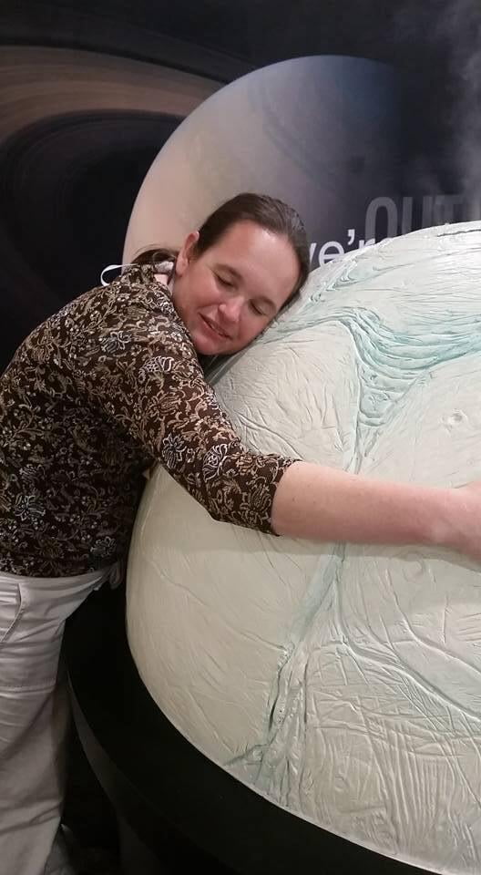 Woman hugging a small round moon